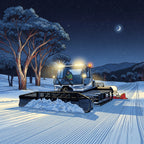 Snow grooming machine on a snowy trail at night with trees and mountains in the background.