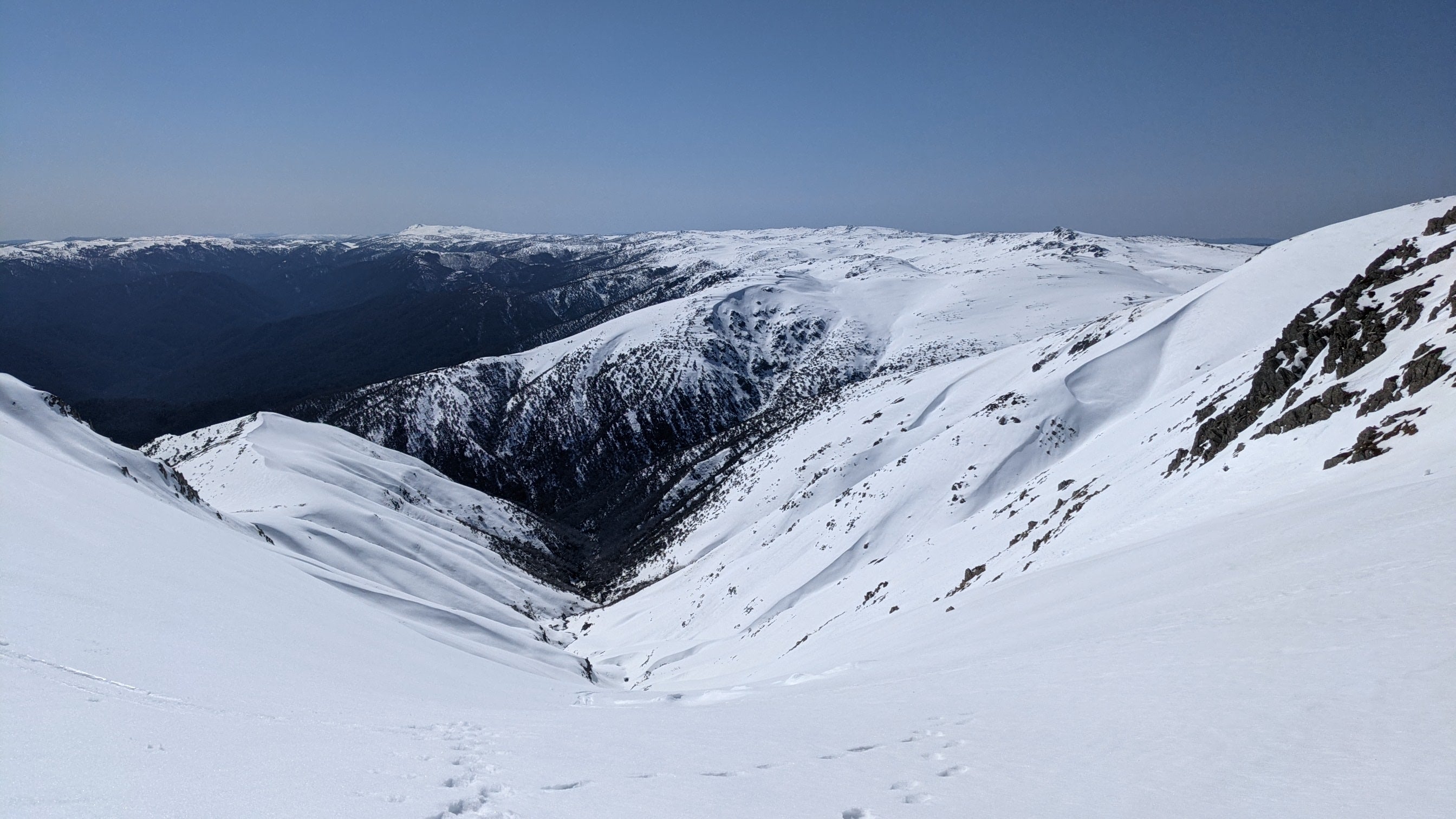 Snowy mountain landscape with a clear blue sky