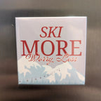 Square magnet with 'Ski More Worry Less' text on a reflective surface
