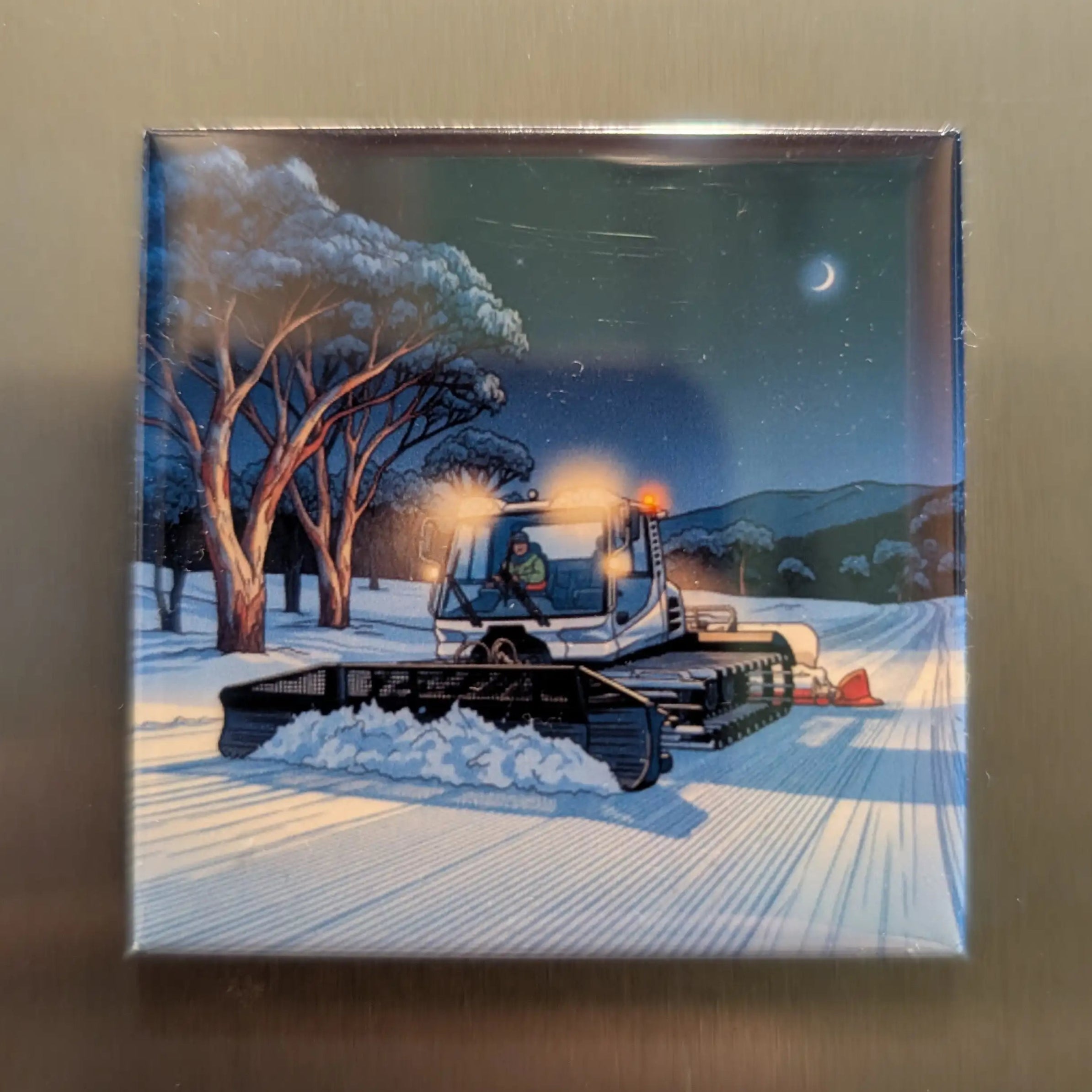 Winter scene with a snowplow grooming a trail at night.